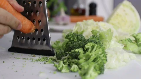 Grating Carrot over a white board. Stock Footage 129249216