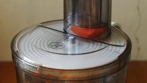 Grating carrots using a food processor Stock Footage 78489576