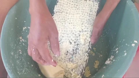 Grating cassava using traditional homemade metal grater in rural village Video stock 341666844