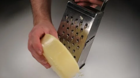 Grating cheddar cheese Stock Footage 240134221