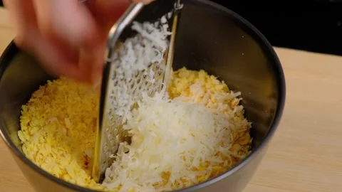 Grating Cheese into Bowl Cooking Kitchen Close-up Video stock 341441793