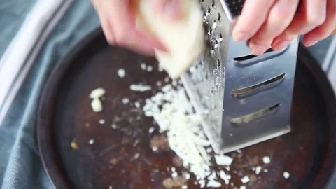 Grating cheese with box grater Stock Footage 75422182