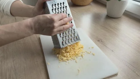 Grating Cheese On Metal Grater Close Cooking Process Kitchen Food Preparation Video stock 336449017