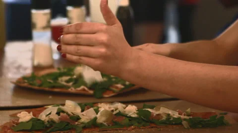 Grating cheese over flatbread Stock Footage 30462619