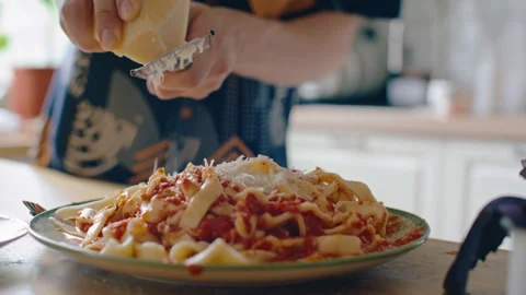 Grating Cheese over Freshly Prepared Homemade Pasta with Sauce Stock Footage 313010720