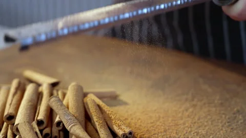 Grating cinnamon sticks. Slow motion video. The spices fall slowly on the board. Stock Footage 233617098