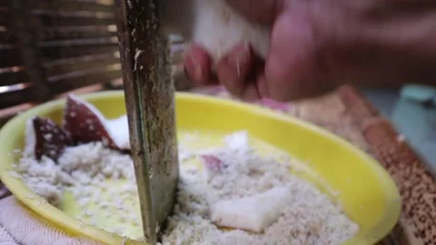 Grating coconut by hand without an electric grater. 스톡 동영상 341834990