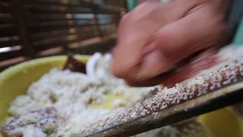 Grating coconut by hand without an electric grater. Video stock 341835113