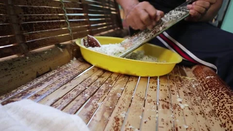 Grating coconut by hand without an electric grater. Stock-Footage 341835115
