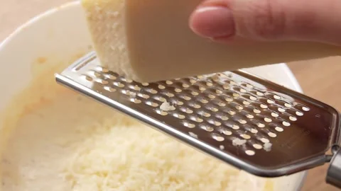 Grating Fresh Cheese Over Bowl Close-up. Stock Footage 255746070