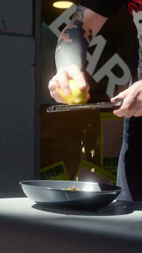 Grating Fresh Lemon Zest Over Dish in Slow Motion Stock Footage 339275531