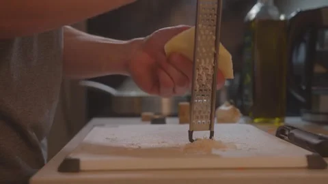 Grating parmesan cheese on cutting board- Sweet Potato Saffron Risotto (Clip 48) Stock Footage 243085880