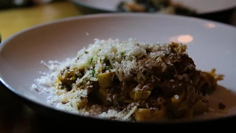 Grating Parmesan Cheese over Spaghetti Pasta Dish with Tomato Sauce Vídeo Stock 320644032