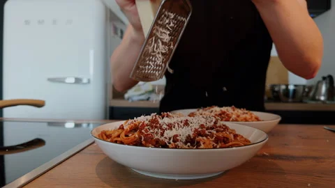 Grating Parmesan Over Spaghetti Bolognese at Home Stock Footage 340190271