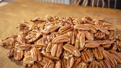 Grating pecans. A pile of pecans Slow motion video 50fps. Stock Footage 305387043