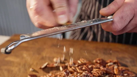 Grating pecans. A pile of pecans Slow motion video 50fps. The spices fall slowly Stock Footage 305387245