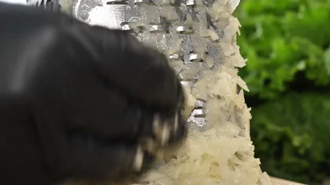 Grating Potato into Rustic Shreds for Stock Footage 311391053