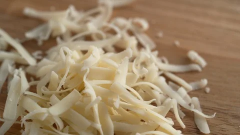 Grating white cheddar cheese. Slow Motion. Stock Footage