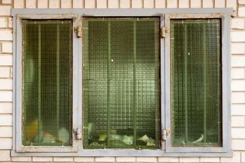 Grating window in the wall in a brick wall Stock Photos