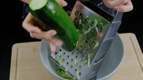 Grating Zucchini into Bowl Cooking Kitchen Preparation Video stock 341425281