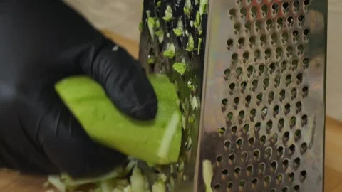 Grating Zucchini with Kitchen Grater Stock Footage 311318401