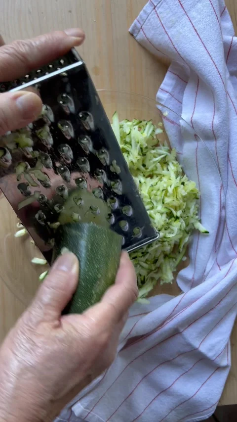 Grating zucchini vertical vew 스톡 동영상 247663828
