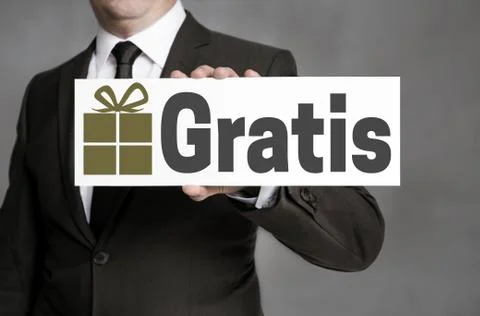 Gratis (in german Free of Charge) shield is held by businessman Stock Photos