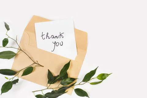 Gratitude note on a white paper with an envelope on a white background Stock Photos