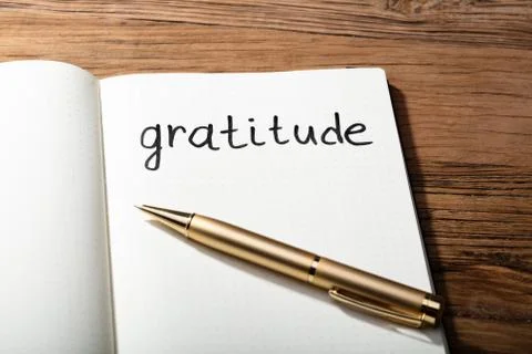 Gratitude Word With Pen On Notebook Stock Photos
