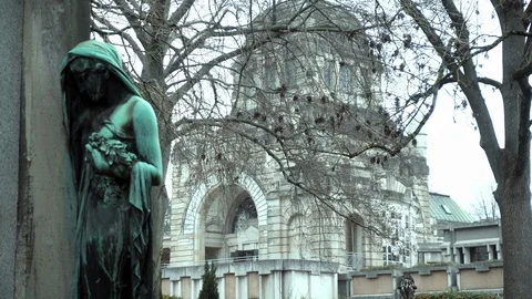 Grave figure with church in the background Stock Footage 100379596