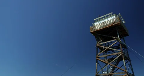 Grave Point fire lookout rises above the rim of Hells Canyon Stock Footage 127618200