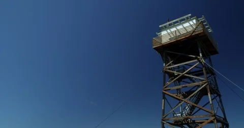 Grave Point fire lookout rises above the rim of Hells Canyon Stock Footage 127620230