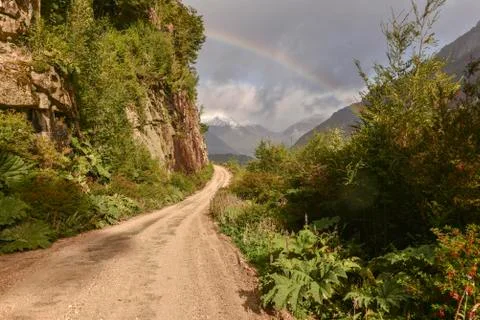 Gravel road with rainbow at Puerto Rio Tranquilo Carretera Austral Valle Stock Photos