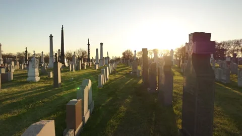 Graves in an empty cemetery at sunset Stock Footage 256860158