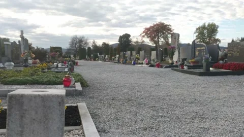 Graves in a local cemetery. Candles and flowers on well maintained graves Video stock 141386953