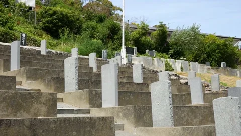 GraveStone Pan up drapped flag Stock Footage 147287969