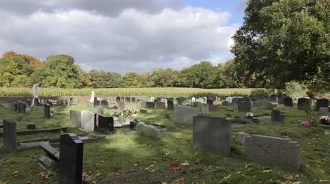 Graveyard cemetry moody sky moving clouds trees rural Stock Footage 57238264