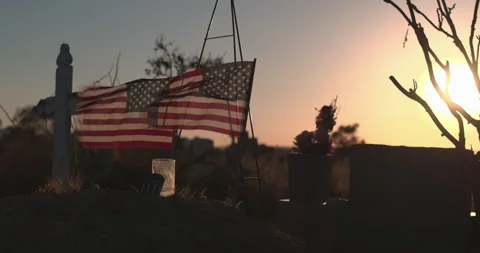 Graveyard at Golden Hour with American Flags &amp; Cross slow motion, 4K Stock Footage 290243178