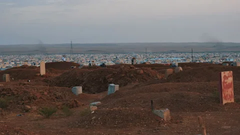 Graveyard next to a refugee camp West Mosul. Isis impact. Nov. 10, 2017, Mosul Stock Footage 158380391