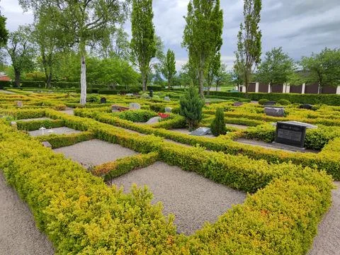 Graveyard with rows of boxed hedges and gravel paths 스톡 사진