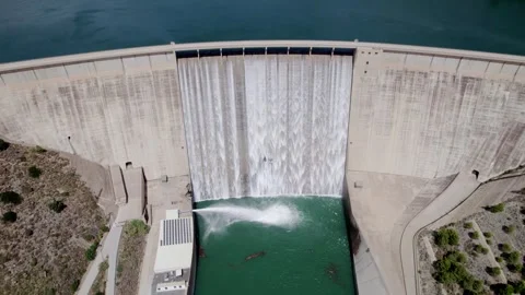 Gravity dam operating at full capacity. Aerial view with zoom-out. Rules Dam Stock Footage 340918572