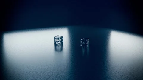 Gravity pulling two glass cubes falling and rotating onto textured table, Stock Footage 340268359