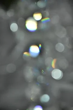 Gray abstract background with white and colored bokeh Stock Photos