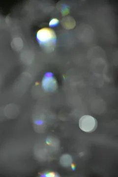 Gray abstract background with white and colored bokeh Stock Photos