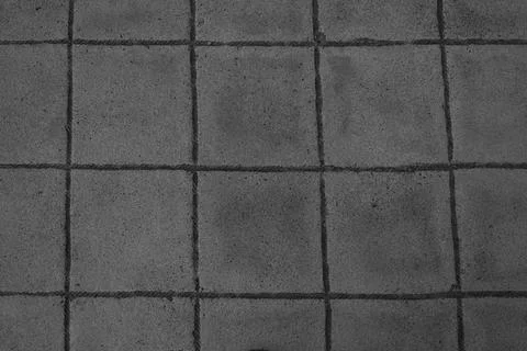 Gray abstract pattern background of grey red cobblestone pavement in close-up Stock Photos