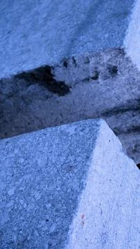 Gray abstract rough stone background. The texture of the stone wall. Close-up. Stock Photos