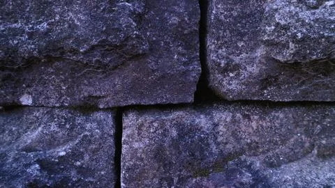 Gray abstract rough stone background. The texture of the stone wall. Close-up. Stock-Fotos