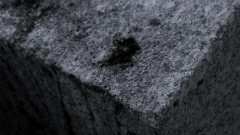 Gray abstract rough stone background. The texture of the stone wall. Close-up. Stock Photos