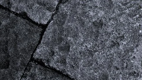 Gray abstract rough stone background. The texture of the stone wall. Close-up. Stock Photos