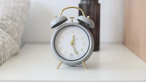 Gray alarm clock stands near the bed timelapse. Stock-Footage 238705200